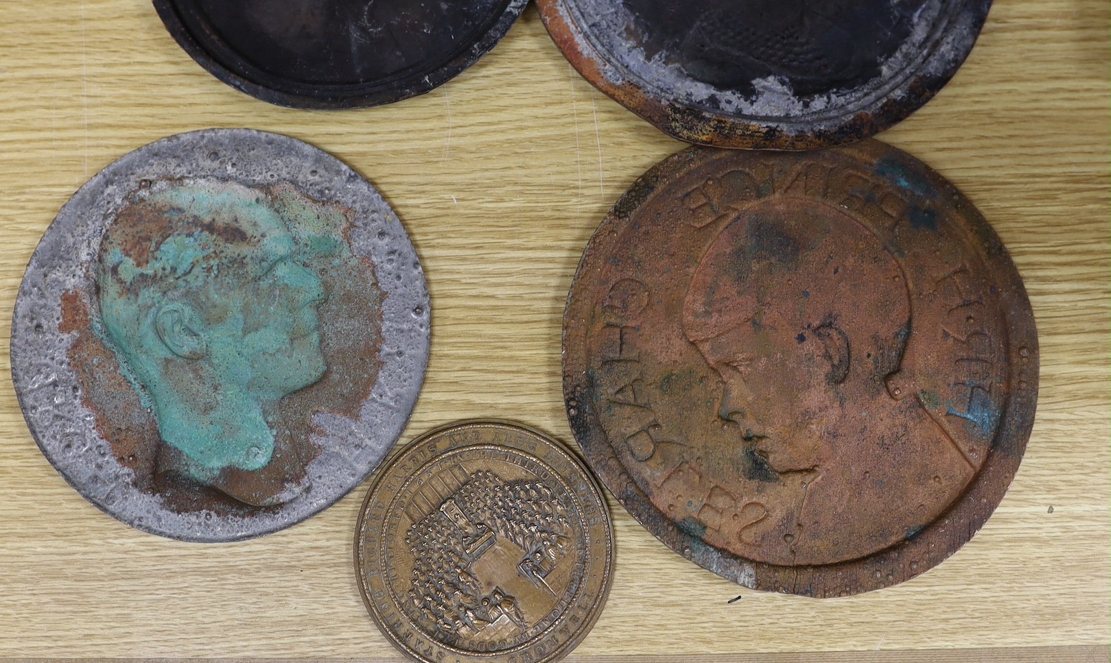 A group of six various cast copper or bronze medallion roundels. Largest 28cm diameter